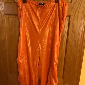 Akira light weight orange shimmer parachute joggers. NWT size Large